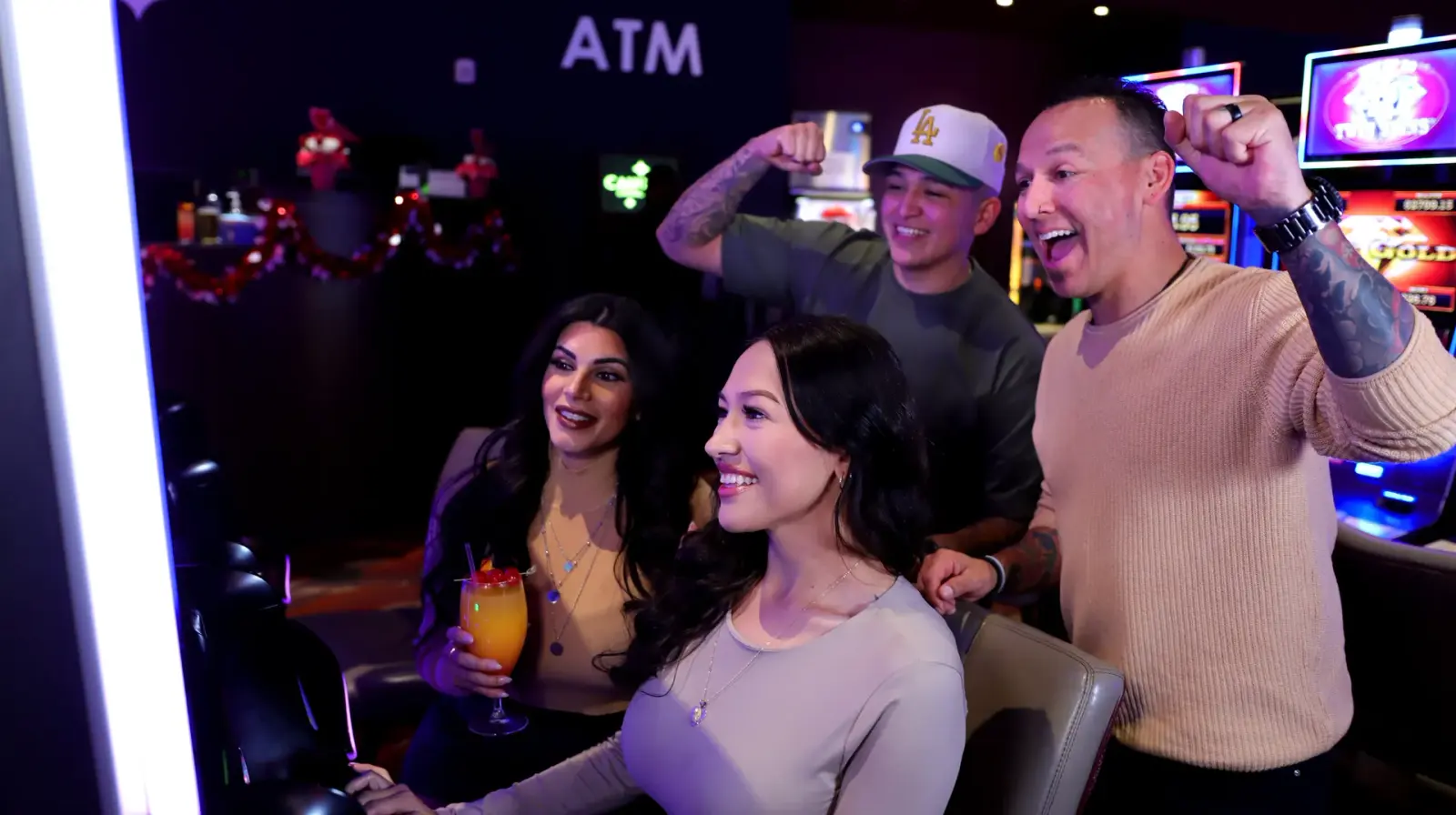 Friends cheering at a slot machine at the Cahuilla Casino